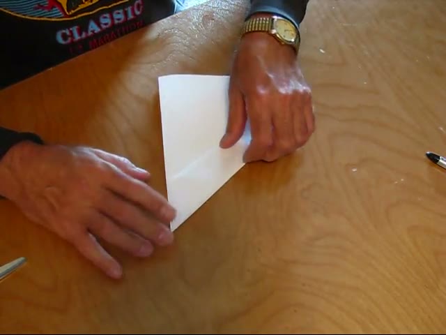 The sheet folded in half while the second flap is folded to match