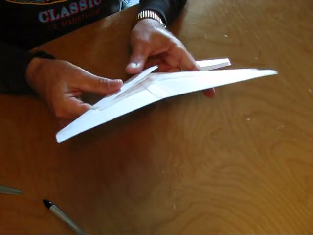 Mike holding the wing up while taping the cover, following the twist